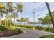 Scenic community pathway with views of palm trees, and waterfront at 2739 Via Capri # 1011, Clearwater, FL 33764