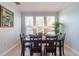 Bright dining room with a dark wood table and large windows at 2739 Via Capri # 1011, Clearwater, FL 33764