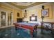 Game room features a pool table, elegant decor, wall art and tiled floors at 2739 Via Capri # 1011, Clearwater, FL 33764