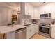 Bright kitchen features stainless steel appliances, white cabinets, and stylish countertops at 2739 Via Capri # 1011, Clearwater, FL 33764