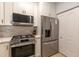 The kitchen includes a stainless steel refrigerator, a built-in microwave, and a gas range oven at 2739 Via Capri # 1011, Clearwater, FL 33764
