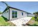 Exterior view showcasing the backyard with a patio and lush green grass at 3004 W Abdella St, Tampa, FL 33607