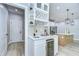 Modern bar area featuring a wine cooler, additional storage, and access to the kitchen at 3004 W Abdella St, Tampa, FL 33607