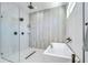 Bathroom featuring a modern soaking tub and glass-enclosed shower at 3004 W Abdella St, Tampa, FL 33607