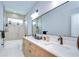 Elegant bathroom with double vanity, large mirror, and modern fixtures at 3004 W Abdella St, Tampa, FL 33607