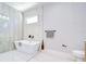 Bright bathroom with a luxurious soaking tub and modern tiling at 3004 W Abdella St, Tampa, FL 33607