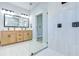 Modern bathroom with a glass-enclosed shower and light wood double vanity at 3004 W Abdella St, Tampa, FL 33607