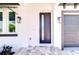 Close up of a modern front door with sidelight and exterior lighting fixtures at 3004 W Abdella St, Tampa, FL 33607