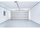 Spacious garage with a roll-up door and a clean, painted floor at 3004 W Abdella St, Tampa, FL 33607