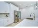 Modern kitchen featuring stainless steel appliances, white cabinetry, and marble countertops at 3004 W Abdella St, Tampa, FL 33607