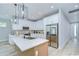 Bright kitchen featuring white cabinetry, stainless steel appliances, and quartz countertops at 3004 W Abdella St, Tampa, FL 33607