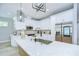 Bright kitchen featuring white cabinetry, stainless steel appliances, and quartz countertops at 3004 W Abdella St, Tampa, FL 33607