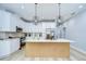 Bright kitchen featuring white cabinetry, stainless steel appliances, and quartz countertops at 3004 W Abdella St, Tampa, FL 33607