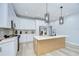 Bright kitchen featuring white cabinetry, stainless steel appliances, and quartz countertops at 3004 W Abdella St, Tampa, FL 33607