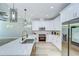 Bright kitchen featuring white cabinetry, stainless steel appliances, and quartz countertops at 3004 W Abdella St, Tampa, FL 33607