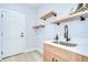 The laundry room features a modern sink with floating shelves and a doorway to the outside at 3004 W Abdella St, Tampa, FL 33607