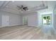 Spacious living room featuring tray ceilings, a ceiling fan, recessed lighting, and access to the yard at 3004 W Abdella St, Tampa, FL 33607
