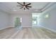 Spacious living room featuring tray ceilings, a ceiling fan, recessed lighting, and access to multiple rooms at 3004 W Abdella St, Tampa, FL 33607