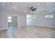 Spacious living room featuring tray ceilings, a ceiling fan, recessed lighting, and access to multiple rooms at 3004 W Abdella St, Tampa, FL 33607