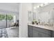 Elegant bathroom featuring gray vanity with marble countertop and access to a private outdoor patio at 301 2Nd N St # 15, St Petersburg, FL 33701