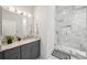 Bright bathroom featuring marble countertop, modern vanity, and stylish glass enclosed shower with white marble tiling at 301 2Nd N St # 15, St Petersburg, FL 33701