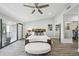Bright primary bedroom featuring a ceiling fan, private balcony, and wood-look tile flooring at 301 2Nd N St # 15, St Petersburg, FL 33701