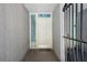 View of the entryway with a white door, storm door, glass sidelight and brick paver flooring at 301 2Nd N St # 15, St Petersburg, FL 33701