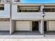 This townhome features a carport with white doors, a neutral color scheme, and a second story porch area at 301 2Nd N St # 15, St Petersburg, FL 33701
