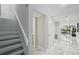 Bright hallway with stairs, marble flooring, neutral paint and access to a half bath and back living space at 301 2Nd N St # 15, St Petersburg, FL 33701
