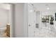 View of a hallway with marble flooring, access to a half bath, and an opening to the backyard at 301 2Nd N St # 15, St Petersburg, FL 33701