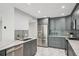 Modern kitchen with stainless steel appliances, gray cabinetry, marble countertops and tile backsplash at 301 2Nd N St # 15, St Petersburg, FL 33701