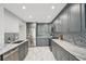 Contemporary kitchen with gray cabinets, stainless steel appliances, and marble countertops at 301 2Nd N St # 15, St Petersburg, FL 33701