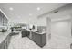 Stylish kitchen with gray cabinetry, marble floors and view of the living room and outdoor patio at 301 2Nd N St # 15, St Petersburg, FL 33701
