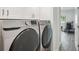 Updated laundry room featuring side-by-side Samsung washer and dryer and white cabinets for storage at 301 2Nd N St # 15, St Petersburg, FL 33701