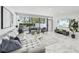 Bright living room featuring tile floors, modern decor, and sliding glass doors to the patio at 301 2Nd N St # 15, St Petersburg, FL 33701