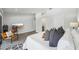 Spacious main bedroom featuring stylish decor, seating area, a large bed, and gray wood flooring at 301 2Nd N St # 15, St Petersburg, FL 33701
