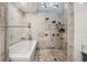 Modern bathroom featuring a soaking tub and glass-enclosed shower with premium fixtures and neutral tile at 301 2Nd N St # 15, St Petersburg, FL 33701