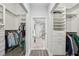 Bright walk-in closet with custom built-in shelving and a bathroom view, offering ample storage space at 301 2Nd N St # 15, St Petersburg, FL 33701