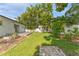 A spacious backyard featuring lush green grass, a shed, and a privacy fence at 3125 W Fielder St, Tampa, FL 33611
