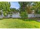 Beautiful backyard with lush green grass, mature trees, and a white privacy fence at 3125 W Fielder St, Tampa, FL 33611