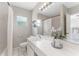 Clean, bright bathroom with white tile, a large mirror and updated fixtures at 3125 W Fielder St, Tampa, FL 33611