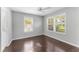 Light-filled bedroom with dark floors, ceiling fan and large windows at 3125 W Fielder St, Tampa, FL 33611