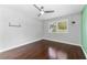Bright bedroom with hardwood floors, a ceiling fan, and large window with shutters at 3125 W Fielder St, Tampa, FL 33611