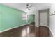 Bright bedroom features a ceiling fan, mirrored closet doors, and hardwood floors at 3125 W Fielder St, Tampa, FL 33611