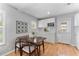 Cozy dining area featuring an adjacent kitchen with natural light, wood floors and modern design at 3125 W Fielder St, Tampa, FL 33611