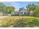 Charming home with well-maintained lawn and landscaping featuring a palm tree at 3125 W Fielder St, Tampa, FL 33611