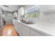 Bright kitchen with white cabinets, stainless steel appliances and a window at 3125 W Fielder St, Tampa, FL 33611