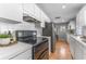 Bright kitchen with modern appliances, white cabinets, and hardwood floors at 3125 W Fielder St, Tampa, FL 33611