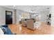 Inviting living space featuring hardwood floors, neutral paint, seamless flow to kitchen, and ceiling fan at 3125 W Fielder St, Tampa, FL 33611
