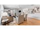 Open-concept living area with hardwood floors, neutral paint, and seamless flow to bedroom and kitchen at 3125 W Fielder St, Tampa, FL 33611